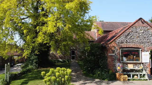 Flint barns and shops in the upper courtyard